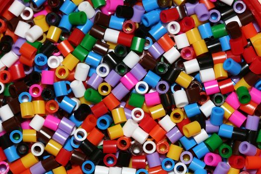 A macro shot of a bunch of small plastic thingies, all kinds of colors.