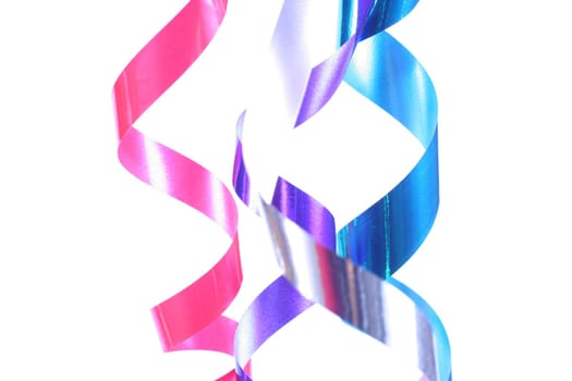 Shiny colorful satin ribbons hanging in curls. Holiday, celebration, party theme.