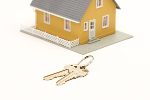 Keys and House isolated on a white background. Focus is on the keys.