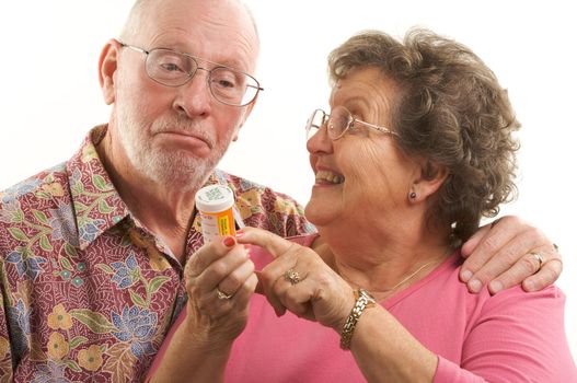 Senior Couple reads a perscription bottle.