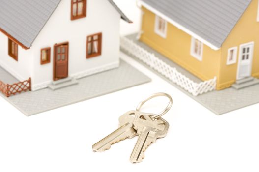 Keys and Houses isolated on a white background. Focus is on the keys.