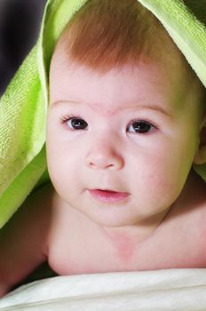 baby looking out from under blanket. Baby at the night.