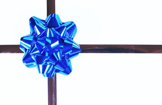 Blue satin bow and gold ribbons on white background.