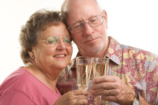 Happy Senior Couple toasting with Champagne glasses.