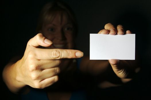 Abstract of Woman Holding Blank Business Card. Room for text and your own message.