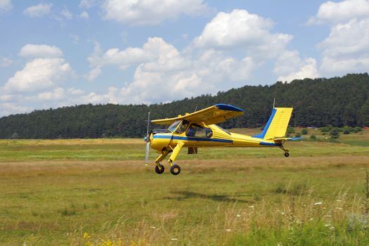 Yellow plane taking off