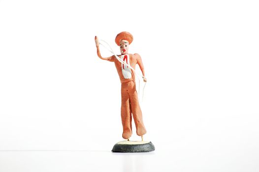 Whimsical mexican clay toy cowboy on a white background.