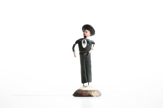 Whimsical mexican clay toy cowboy on a white background.