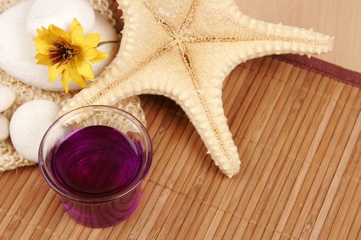 Spa still-life with star fish, stones, flower and aroma therapy bottle