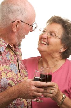 Happy Senior Couple toasting with Winee glasses.