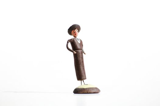 Whimsical mexican clay toy cowboy on a white background.