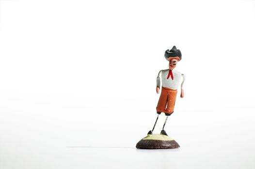 Whimsical mexican clay toy cowboy on a white background.