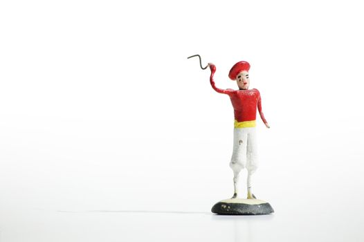 Whimsical mexican clay toy cowboy on a white background.