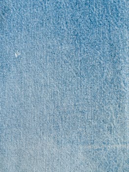 Striped textured used blue jeans denim fabric grunge background