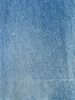 Striped textured used blue jeans denim fabric grunge background