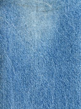 Striped textured used blue jeans denim fabric grunge background