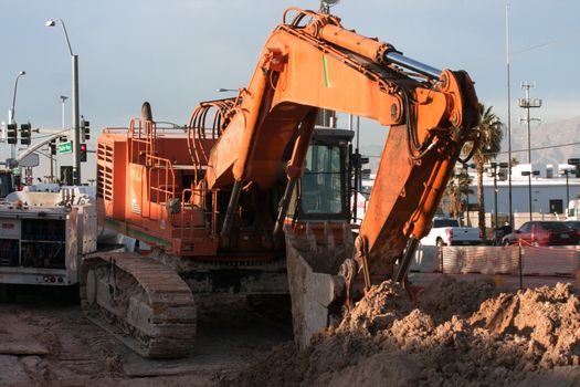excavator in city, repairing sewer line