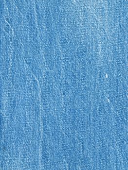 Striped textured used blue jeans denim fabric grunge background