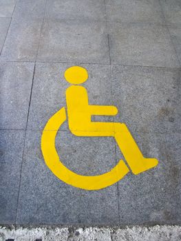 Yellow handicapped sign of floor tile