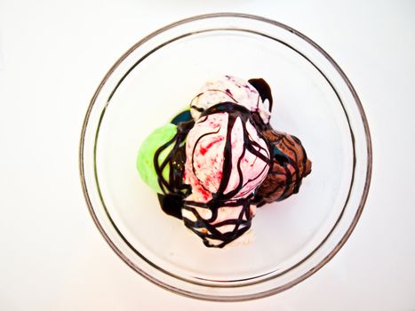 Ice cream with chocolate in a glass bowl topview isolated on white