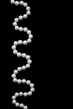 White pearls on the black silk can use as background 