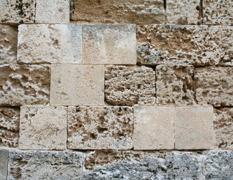 Greece. Rhodos island. Abstract old colorful stone wall can use as background 