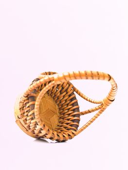 A yellow wicker basket isolated on white background