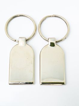 A pair of metalic trinket keychain isolated on white background