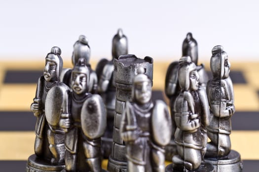 Rook peice surrounded by pawn pieces with bright background