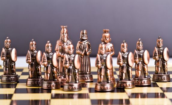 brass chess set arrangement with focus on the bishop piece