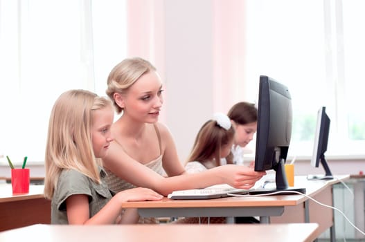 teacher explains the task schoolgirl at the computer, the new technologies in education