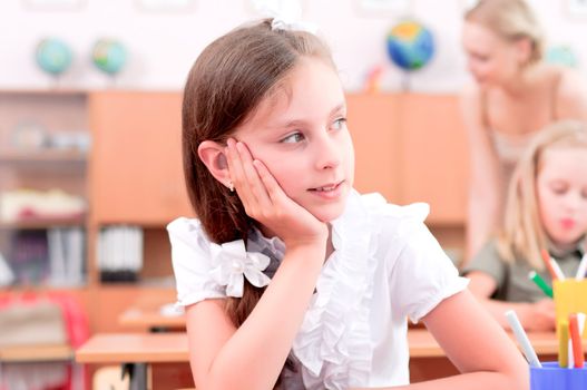 portrait of students in the classroom, sit at school desks