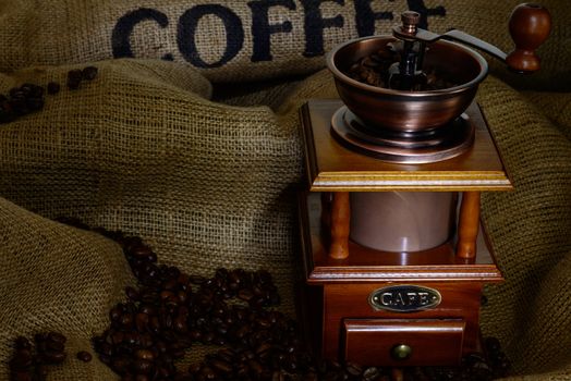 Coffee Mill with beans and burlap. still life