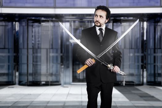 Businessman with two Japanese swords at the entrance of an office building