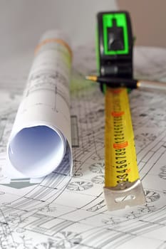 architectural instruments over white paper with printed plans