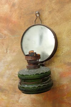 old gas lamp hanging on a painted wall as decorative object