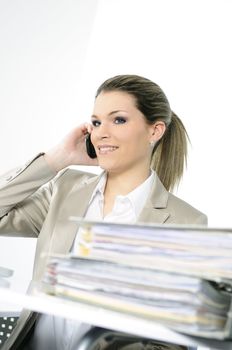 Closeup of businesswoman in the office talking on the phone