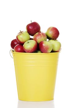 Fresh red apples in yellow bin, isolated on white