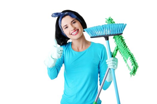 Happy cleaning woman gesturing thumbs up, isolated on white