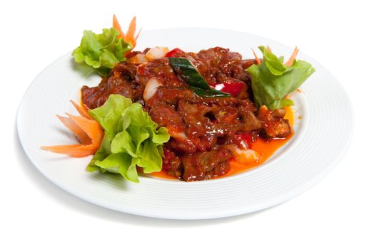 Roasted beef with vegetables on a plate isolated on white