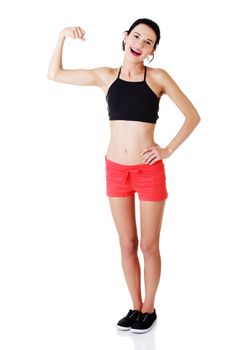 Portrait of beautiful young lady flexing her biceps on isolated white background