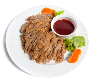 Battered pork with sauce on a plate isolated on white