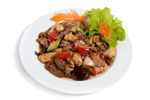 Roasted meat with vegetables on a plate isolated on white