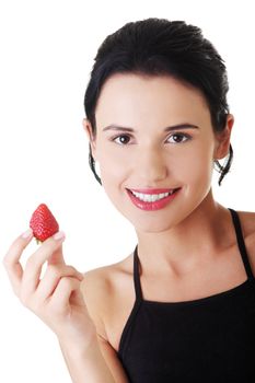 Pretty fit woman eating strawberries , isolated on white