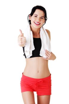Attractive fitness woman in sport clothes gesturing thumbs up, isolated on white