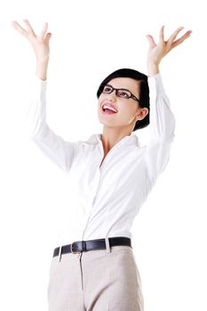 Smiling young woman is holding something abstract above her head. Happy girl with raised hands. Isolated on white background.