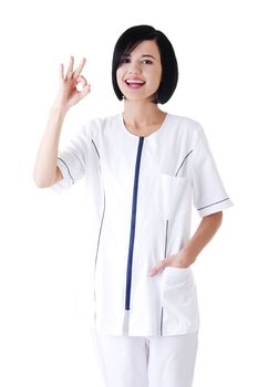 Young female doctor or nurse gesturing perfect . Isolated
