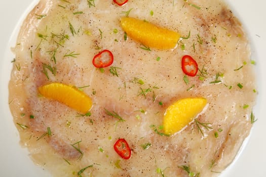 carpaccio of fish with orange and erbs