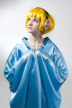 Cosplay girl in blue kimono with yellow hair