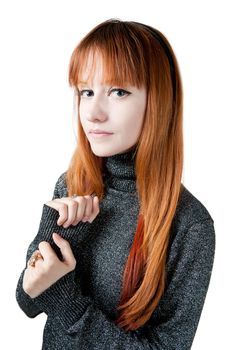 The beautiful girl with red long hair in a sweater isolated on white